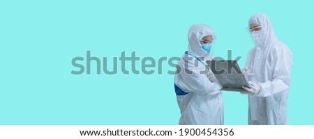Doctor in hospital analyzing covid-19 wearing protective suite in laboratory looking document on hand ,how to protect and treatment with virus concept.