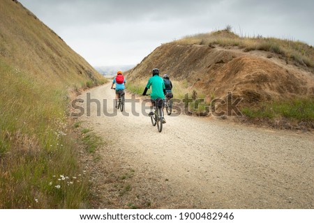 Three people cycling the Otago Central Rail Trail at Poolburn Gorge, South Island