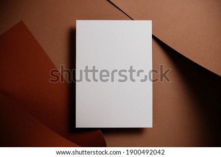 Stylish white blank paper mockup on a colorful background. Document and presentation stationery creator. Selective focus on paper