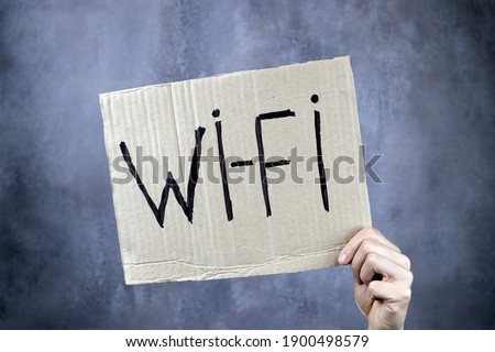 wi-fi poster in hand on gray background