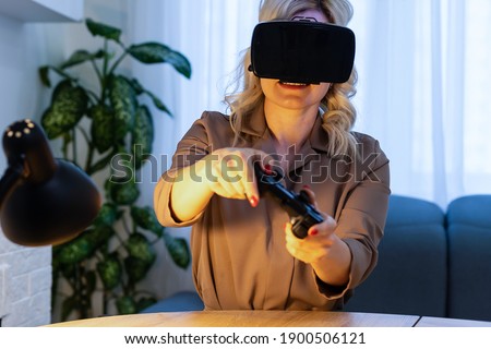 Woman play game with VR device at home