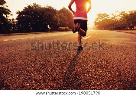Runner athlete running at road. woman fitness sunrise jogging workout wellness concept.  Royalty-Free Stock Photo #190051790