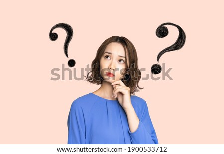 Thinking young asian woman. Confused facial expression. Royalty-Free Stock Photo #1900533712
