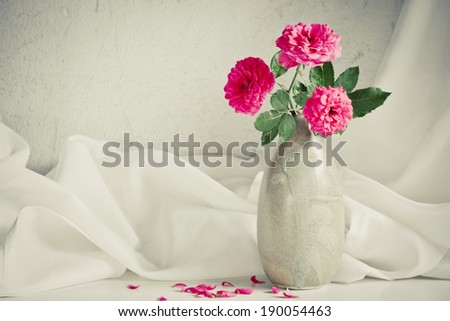 Still life with pink roses flower in ceramic vase