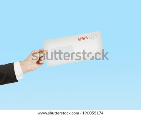 hand giving a envelope on blue background