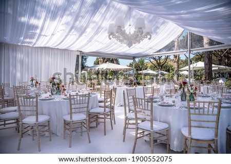 Setting up for the ultimate wedding  venue in a marquee, all in white in Naples Italy Royalty-Free Stock Photo #1900552075
