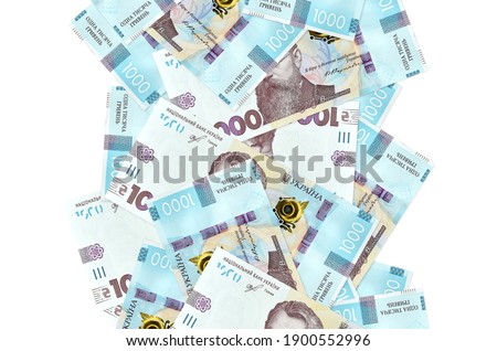 1000 Ukrainian hryvnias bills flying down isolated on white. Many banknotes falling with white copy space on left and right side