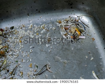 A heavily soiled sink and a drain with leftover food. A blockage in the sink. Advertising of tools for cleaning and removing blockages. Royalty-Free Stock Photo #1900576165