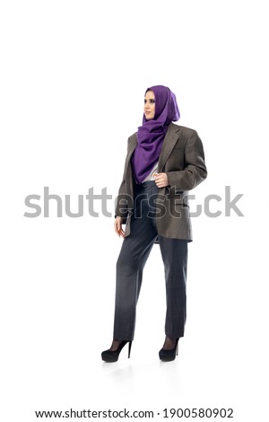 Success. Modern arab woman in stylish office attire isolated on studio background with copyspace for ad. Fashion, beauty, style concept. Female model with trendy make up, manicure and accessories.