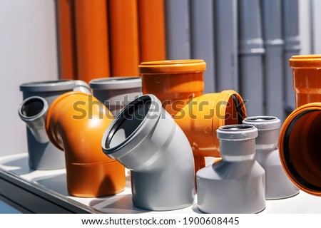 Sewer pvc fittings. Various parts of large diameters for pipeline installation. Close-up Royalty-Free Stock Photo #1900608445