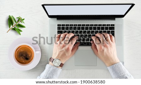 man using laptop on office table, top view