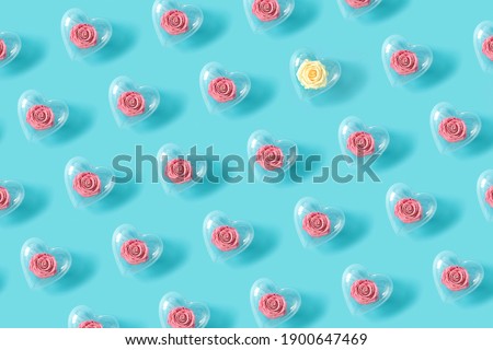 Pattern made of roses in transparent heart shape balloon. Flower wallpaper layout. Minimal flat lay background concept. Royalty-Free Stock Photo #1900647469