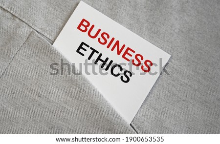 BUSINESS ETHICS text on a whire sticker in a pocket. Buseinss concept.