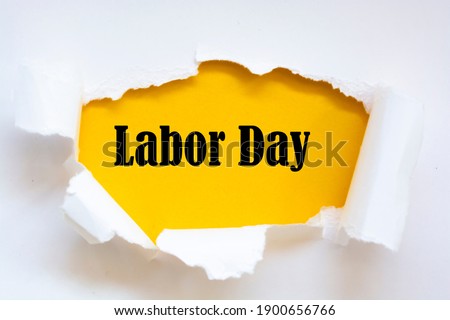 Labor Day written under torn paper. 1st May - Labor Day.