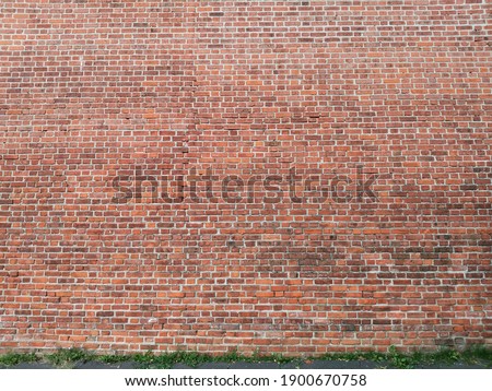 red background - a picture of the brick wall of the old Kremlin fortress in Nizhny Novgorod, Russia