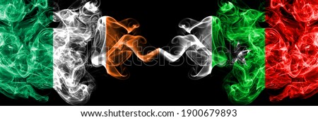 Republic of Ireland, Irish vs Casamance, Senegal  smoky mystic flags placed side by side. Thick colored silky abstract smoke flags.