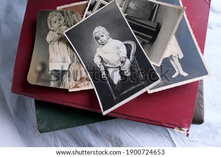 old photo albums lie on a white mint tablecloth, vintage photographs of 1960, concept of family tree, genealogy, childhood memories, connection with ancestors