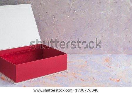   Open gift box in red color on a decorative background