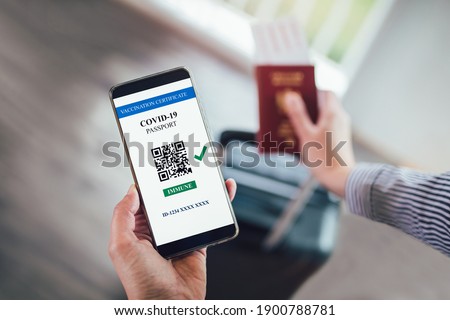  Vaccination, disease immunity passport, health and surveillance concepts. Smartphone displaying a valid digital vaccination certificate for COVID-19 Royalty-Free Stock Photo #1900788781