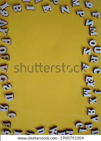 frame of letters on a yellow background with space for text. High quality photo