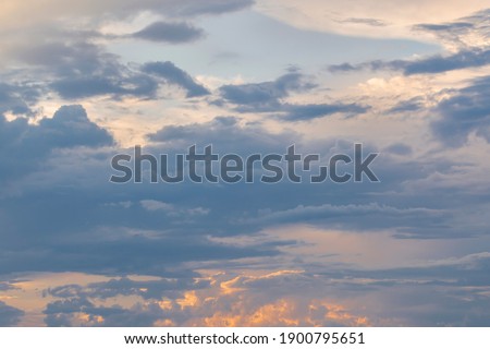 Cloudy sky at sunset in pastel colors. Natural sky background