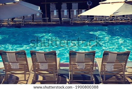 Photo of Sunloungers by swimming pool