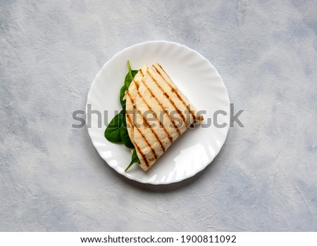 Tortillas with different fillings of mushrooms, cheese, spinach and fried egg. Food trend. Royalty-Free Stock Photo #1900811092