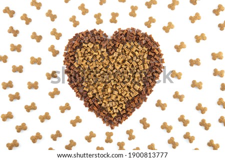 Dried animal pet dog food in heart form isolated on white background . Dog love dry food Biscuits 