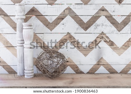 Farmhouse mantle decor on distressed wooden natural and white chevron print background