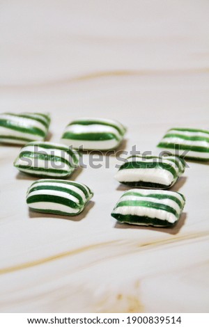 Mint candies arranged in a row, green candies, white and green striped candies