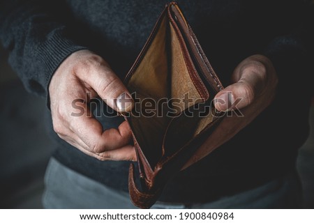 An Empty wallet in the hands of a young man Royalty-Free Stock Photo #1900840984