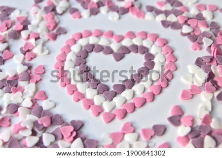 Delicious pink Valentine's Day sugar hearts and ornaments in pink, purple and white show I love you to your girlfriend and beloved people with precious diamonds and red hearts jewelry as special gift