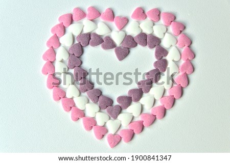 Delicious pink Valentine's Day sugar hearts and ornaments in pink, purple and white show I love you to your girlfriend and beloved people with precious diamonds and red hearts jewelry as special gift