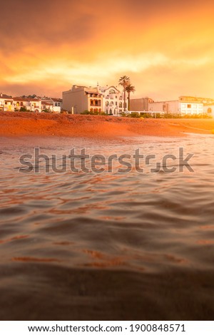 Picture of a hotel in front of the beach of Tossa de Mar in costa brava captured during sunrise. Girona, Spain.