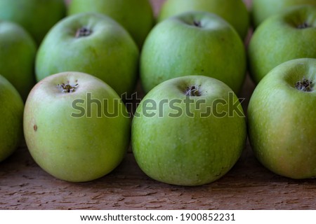 Apples stand on a wooden surface