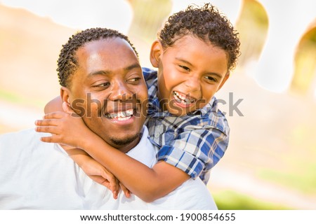 Happy African American Father and Mixed Race Son Playing At The Park. Royalty-Free Stock Photo #1900854655