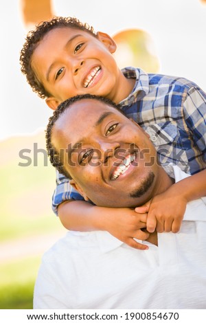 Happy African American Father and Mixed Race Son Playing At The Park. Royalty-Free Stock Photo #1900854670