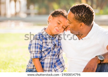 Happy African American Father and Mixed Race Son Playing At The Park. Royalty-Free Stock Photo #1900854796