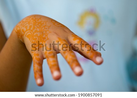 Henna tattoo art on a youth's hand.