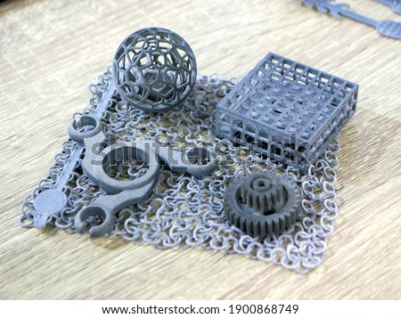 Object printed on powder 3D printer from polyamide powder close-up. Three-dimensional model from thermoplastic gray color. Rapid prototyping, printing products. Progressive modern additive technology Royalty-Free Stock Photo #1900868749