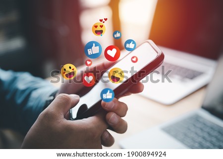 Social media and digital online concept, man using smart phone with Social media. The concept of living on vacation and playing social media. Social Distancing ,Working From Home concept. Royalty-Free Stock Photo #1900894924