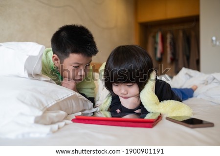 asian chinese child playing smartphone, children watching cartoon, kid use phone
