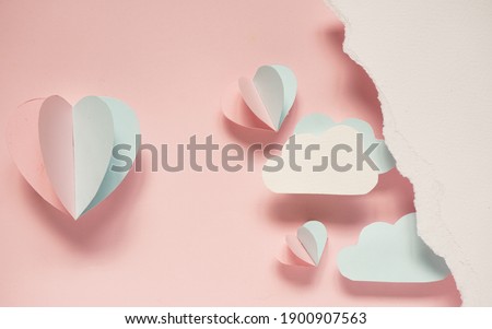 paper cut idea for valentines background, pink and blue paper cut in shape of mini heart and folded like balloon floating in the air and blank space in the left side for edit text,copy space concept. 