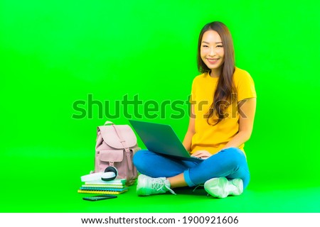 Portrait beautiful young asian woman use computer laptop on green isolated background
