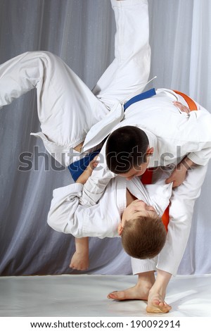 Boys in judogi are training throwing Royalty-Free Stock Photo #190092914
