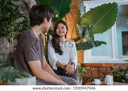 asian young couple having first date in the park