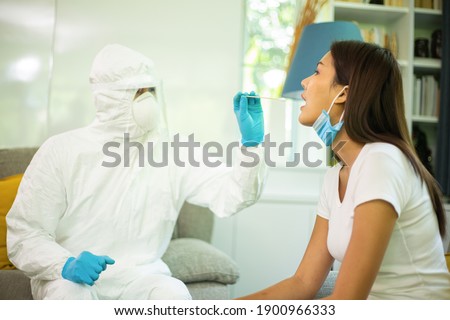 Collect a germ corona virus sample. Staff with PPE suit check suspect person conronavirus. Test health body.Doctor using cotton bud for keep sample disease.