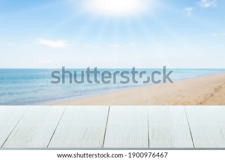 Beautiful wooden floor and blue background, sea water and sky.