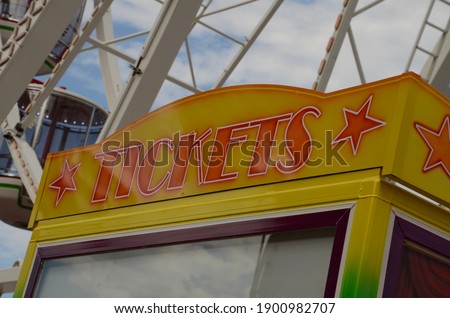 Vintage sign for tickets in bright yellow and orange with stars