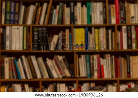 Wooden shelf with books in a row. Education and knowledge. Blurred.